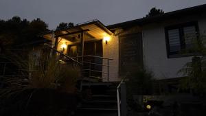 a house with lights on the front of it at FichtelLOFT Retreat-Design Loft nahe Bayreuth in Goldkronach