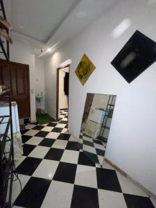 a room with a black and white checkered floor at Mini Studio in Marrakech