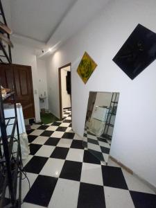 a room with a black and white checkered floor at Mini Studio in Marrakech