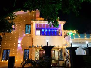 a building with christmas lights on the side of it at Swapno Chhobi in Shānti Niketan