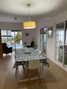 a living room with a dining room table and chairs at 3 Bed Chalet-Pool-Pets-Hot Tub-Parking-Garden in Chiva