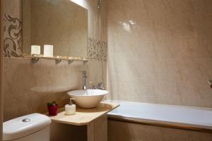 a bathroom with a sink and a tub and a toilet at Transylvanian Nomad II in Cluj-Napoca +16 photos