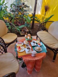 a table with a tray of food on it at O Jardim do Vinho, AC in Praia
