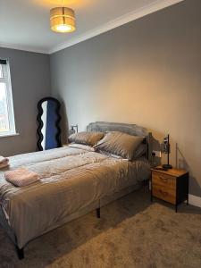 サンダーランドにあるAffordable Luxury 2 Stunning apartment Sunderland close to City centre hospital Crown Works Studio and Nissanのベッドルーム1室(青いヘッドボード付きのベッド1台付)