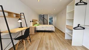 a bedroom with a bunk bed and a desk and a bed at Modern Duplex Studio with BBQ in Molnás