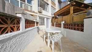 a table and two chairs on a patio at Modern Duplex Studio with BBQ in Molnás