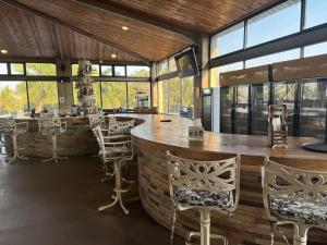 a bar in a room with chairs and windows at Lake Safari Lodge in Siavonga