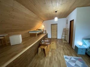 a large room with a bed and a table at Pension Harmony in Liptovský Michal