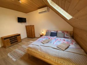 a bedroom with a large bed in a attic at Pension Harmony in Liptovský Michal