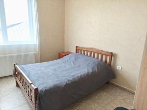 a bedroom with a bed with a blue blanket on it at Urban Harmony in Tsalka