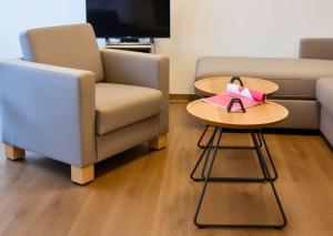a living room with a couch and a table and a chair at Haus Nordland in Juist