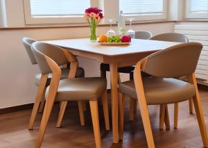 a dining room table with chairs and a bowl of fruit at Haus Nordland in Juist