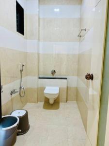 a bathroom with a toilet and a shower at Hotel Apple in Phardāpur +21 photos