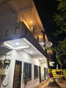 a building with a staircase on the side of it at Ramchandra home stay in Malvan