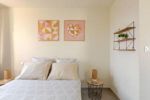 a bedroom with a bed and three pictures on the wall at Charmant appart près Europa-Park Rulantica 30 min in Erstein +24 photos