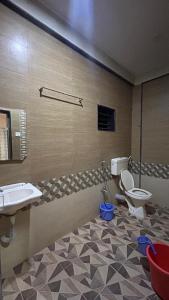 a bathroom with a toilet and a sink at Ramchandra home stay in Malvan