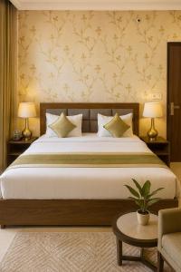 a bedroom with a large bed with two lamps at Hotel Krishna Palace, Vrindavan - Lavish & Luxury rooms with parking near prem mandir #By Om # in Vrindāvan
