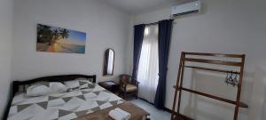 un dormitorio con una cama y una ventana en Mentari Homestay, en Sentool