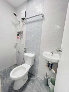 a bathroom with a toilet and a sink at JMary Stayhouse in Nopol