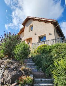 a house on a hill with stairs leading up to it at maison in Le Thillot