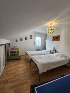 a bedroom with two beds and a tv in it at maison in Le Thillot