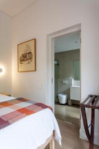 a bedroom with a bed and a bathroom at Minserie Collection in Stellenbosch