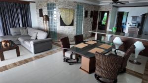 a living room with a table and a couch at Modern apartment in Patong Center in Ban Nong Chaeng