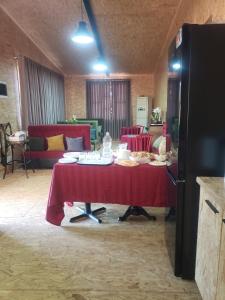a table with plates of food on it in a room at Xhagolands in Përmet