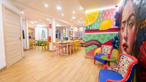 a room with chairs and a table and a colorful wall at Lemon & Green GuestHome in Granada