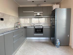 a kitchen with a stainless steel refrigerator and appliances at Entre ciel et mer in Corso Tahtani