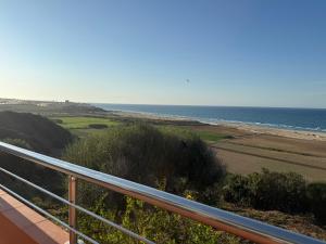 a view of the beach from a balcony at Entre ciel et mer in Corso Tahtani