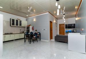 a kitchen and dining room with a table and chairs at Maafolhey Han'dhaan - Ukulhas in Ukulhas