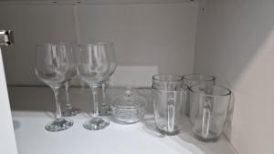 a group of wine glasses sitting on a counter at Apartament EVA in Suceava +1 photo