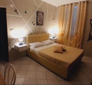 a bedroom with a large bed with two tables and two lamps at Marruvium 1937's in Avezzano