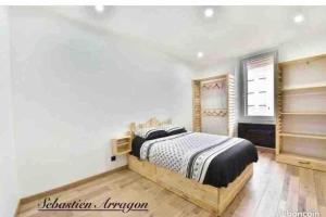 a bedroom with a bed and white walls at Village house in Penne-dʼAgenais