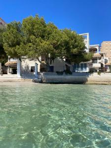 a house sitting on the shore of a body of water at La Manga Caralmar Paraíso in La Manga del Mar Menor
