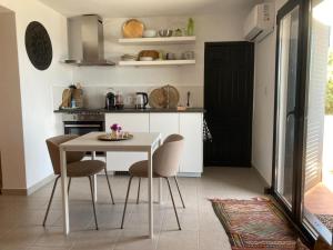 a kitchen with a white table and chairs at La Ladera Bay View in La Herradura +15 photos