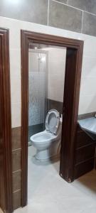 a bathroom with a white toilet and a sink at Petra sharing room in Petra
