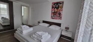 a bedroom with a bed with white sheets and pillows at Penthouse Dream Vista in Čižići