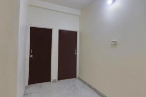 an empty room with three brown doors in it at SPOT ON Hotel Blue Moon in Nagpur