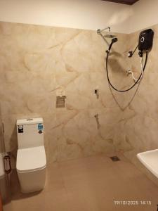 a bathroom with a shower and a toilet and a sink at Scenic Cottage Sigiriya in Sigiriya