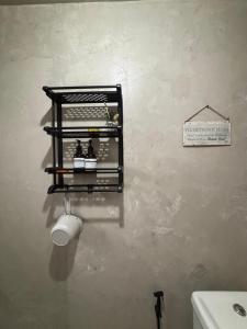 a bathroom with a toilet paper dispenser on a wall at OKBW ConVan in Mameltac