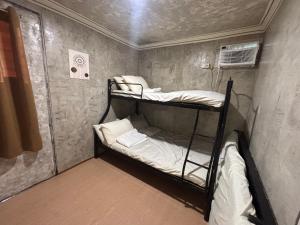 a small room with two bunk beds in it at OKBW ConVan in Mameltac