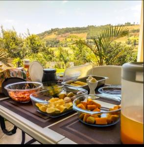 a table with a bunch of food on it at Ekom Nest in Musereita