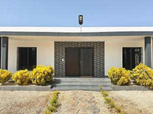 a house with yellow flowers in front of a door at Luxurious 4 bedroom Villa next to the lagoon in Somone
