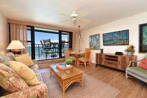a living room with a couch and a table at Kaleialoha 309 · KA 309 Oceanfront Condo AC Ocean Views Heated P in Kahana