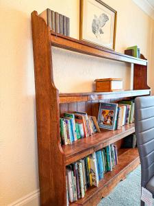 a book shelf filled with books in a room at Watchfield Highbridge in Highbridge