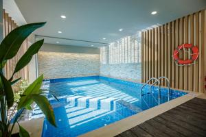 a swimming pool with a red lifebuoy on the wall at Royal Villa Fulidhoo in Fulidhoo