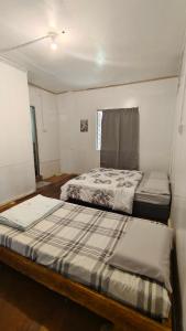 a bedroom with two beds in a room at Rustic B&B in Ranau +4 photos