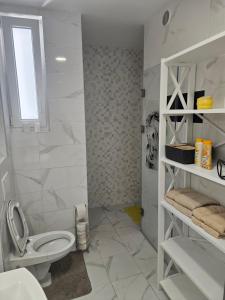 a white bathroom with a toilet and a sink at Miss Extra LuX in Mladenovac +13 photos